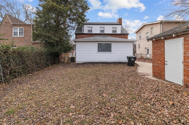 rear view of house featuring central AC