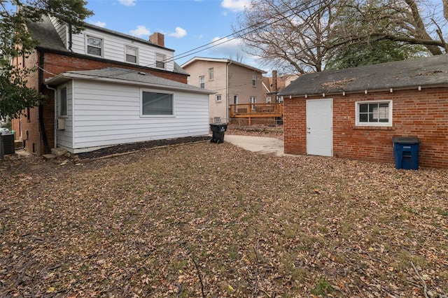 rear view of house featuring central air condition unit