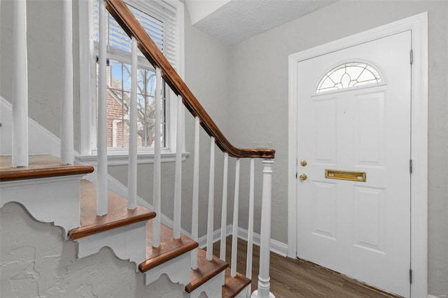 entrance foyer featuring a textured ceiling and hardwood / wood-style flooring