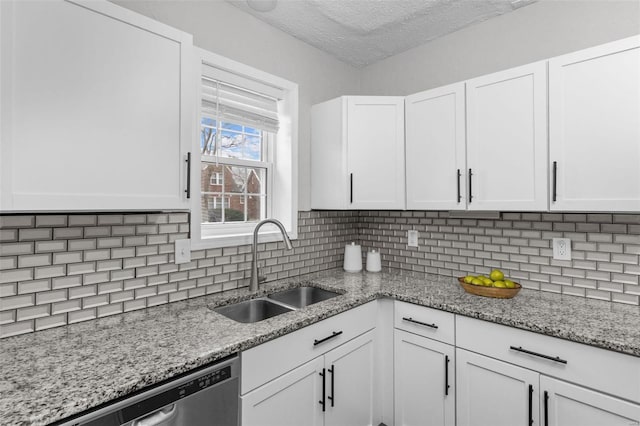 kitchen featuring white cabinets, sink, and tasteful backsplash