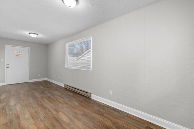 unfurnished room featuring dark hardwood / wood-style flooring and a baseboard radiator