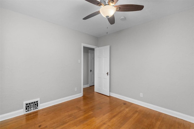 empty room with hardwood / wood-style flooring and ceiling fan