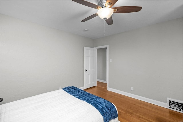 bedroom featuring ceiling fan and hardwood / wood-style flooring