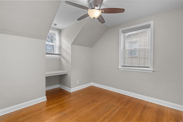 additional living space featuring ceiling fan, hardwood / wood-style floors, and vaulted ceiling