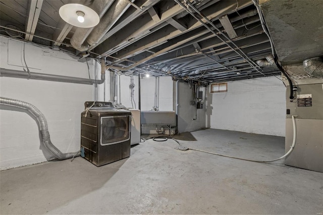 basement featuring sink and heating unit