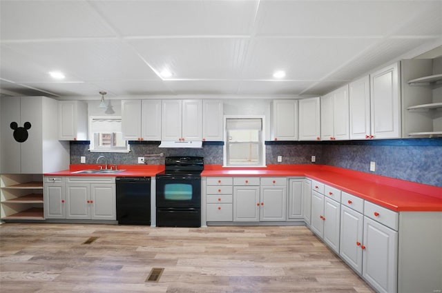 kitchen with tasteful backsplash, ventilation hood, sink, black appliances, and light hardwood / wood-style flooring