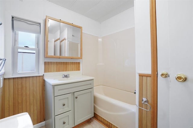 bathroom featuring vanity and wooden walls