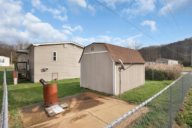 view of side of property featuring a yard and a shed