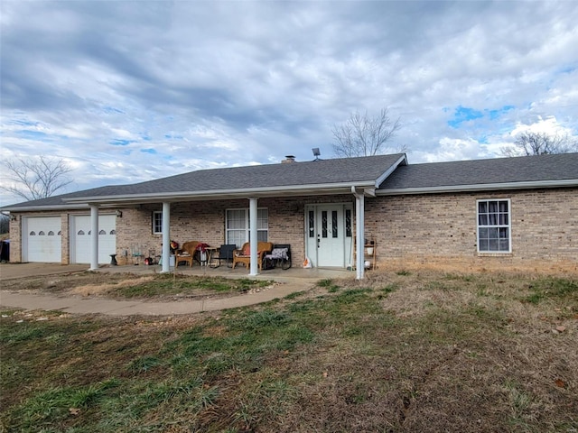 back of property featuring a garage