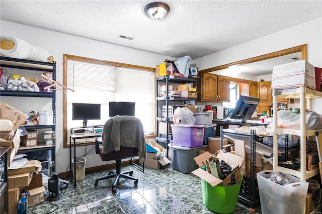 office area with a textured ceiling