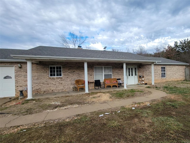 back of property featuring a garage