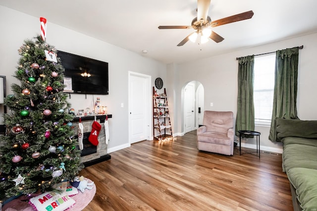 living room with ceiling fan and wood-type flooring