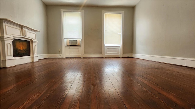 unfurnished living room with cooling unit and hardwood / wood-style flooring