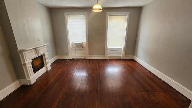 unfurnished living room with cooling unit and dark hardwood / wood-style floors