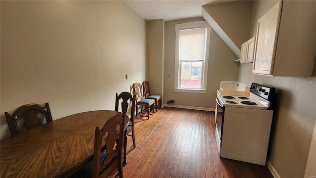 dining area featuring vaulted ceiling, washer / clothes dryer, and dark hardwood / wood-style floors