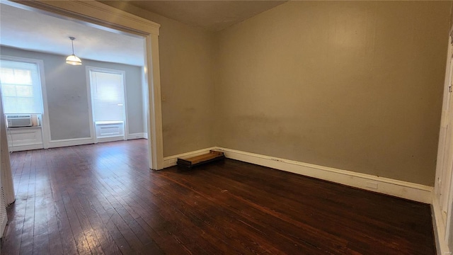 spare room featuring dark hardwood / wood-style flooring and cooling unit