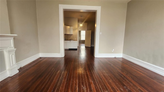 unfurnished living room with dark wood-type flooring