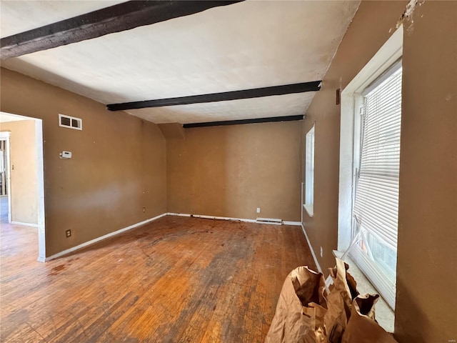 spare room with beamed ceiling and hardwood / wood-style flooring