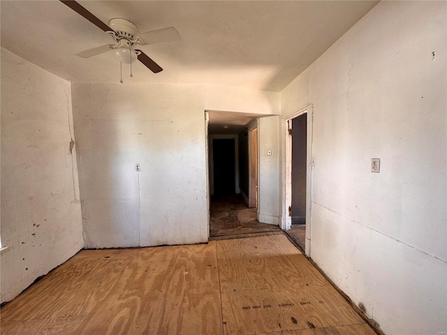 spare room with ceiling fan and wood-type flooring