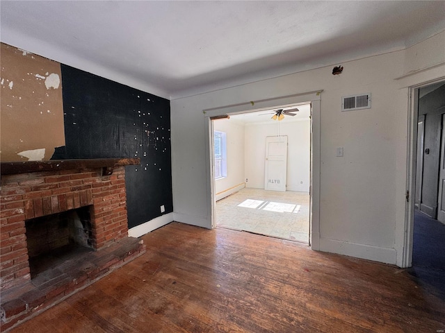 unfurnished living room featuring a brick fireplace, ceiling fan, and hardwood / wood-style flooring