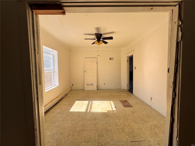 empty room featuring baseboard heating, crown molding, and ceiling fan