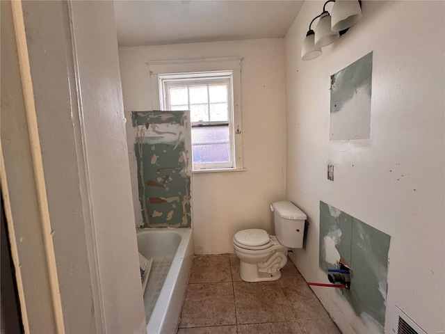 bathroom with tile patterned flooring, toilet, and a washtub