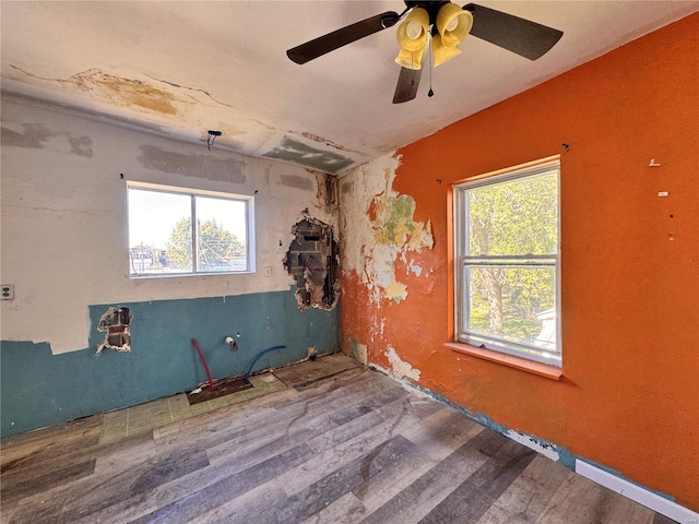 unfurnished room with ceiling fan and hardwood / wood-style floors