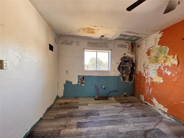 empty room featuring ceiling fan and dark hardwood / wood-style floors