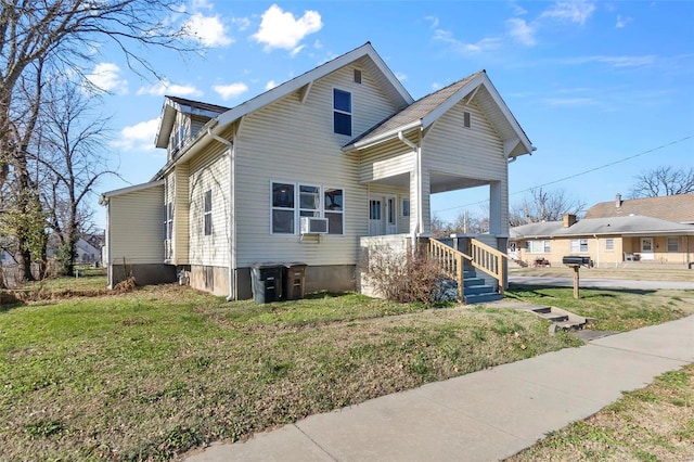 view of front of home featuring cooling unit and a front yard