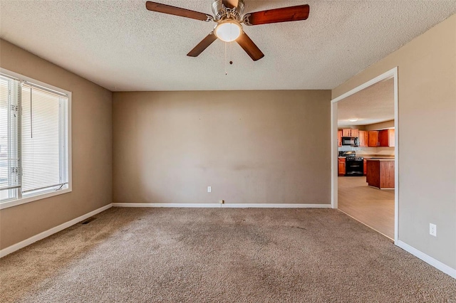 carpeted empty room featuring a textured ceiling and ceiling fan