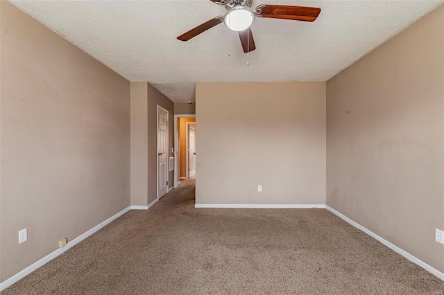 spare room featuring ceiling fan, carpet, and a textured ceiling