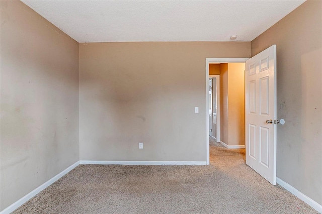 carpeted spare room featuring a textured ceiling