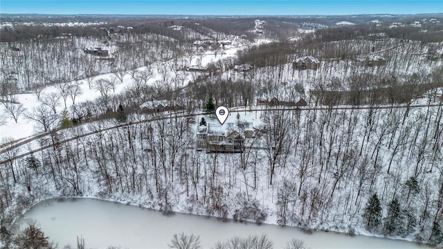 snowy aerial view featuring a water view