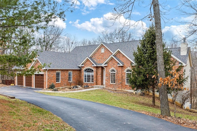 view of front of house with a garage and a front lawn