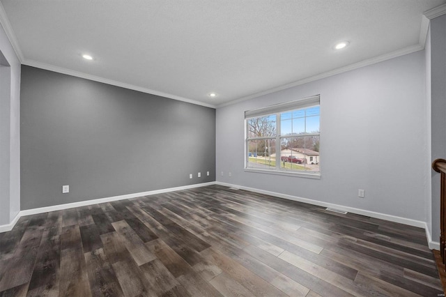 spare room featuring dark hardwood / wood-style floors and ornamental molding