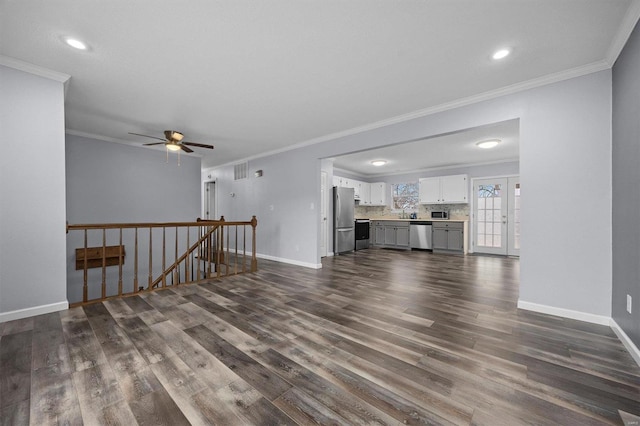 unfurnished living room with dark hardwood / wood-style flooring, ceiling fan, and crown molding