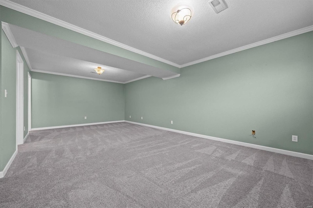 empty room featuring crown molding, carpet floors, and a textured ceiling