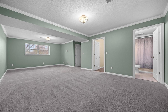 unfurnished bedroom with light carpet, a textured ceiling, ensuite bath, and ornamental molding