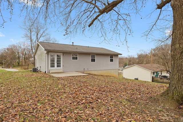 rear view of property with french doors, a patio, and cooling unit