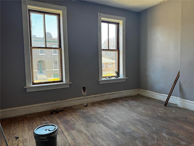 spare room with hardwood / wood-style flooring and a wealth of natural light