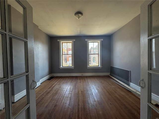 unfurnished room featuring dark hardwood / wood-style flooring