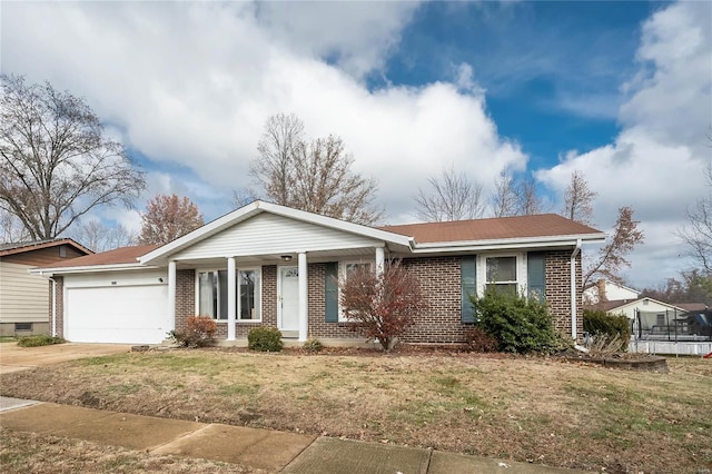 ranch-style home with a garage and a front lawn