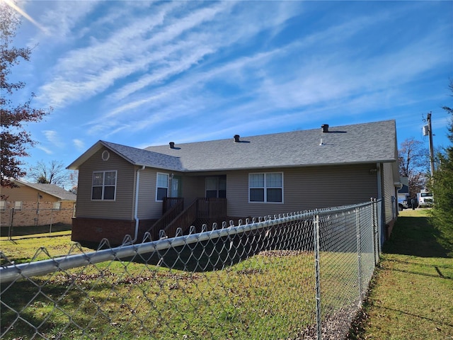 back of property featuring a lawn