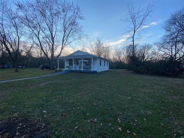 view of front of home with covered porch and a front yard