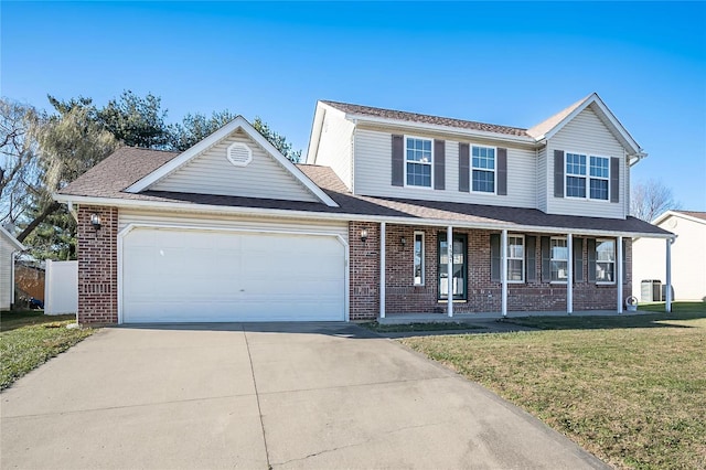 view of front of home featuring covered porch, a garage, and a front lawn