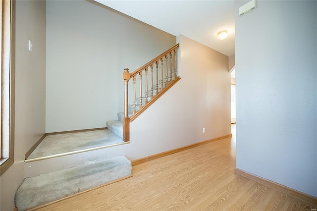 staircase with hardwood / wood-style flooring