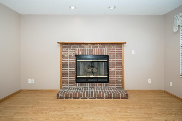 details featuring hardwood / wood-style flooring and a fireplace