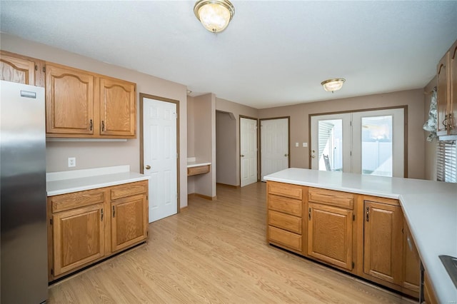 kitchen featuring light hardwood / wood-style floors and stainless steel refrigerator