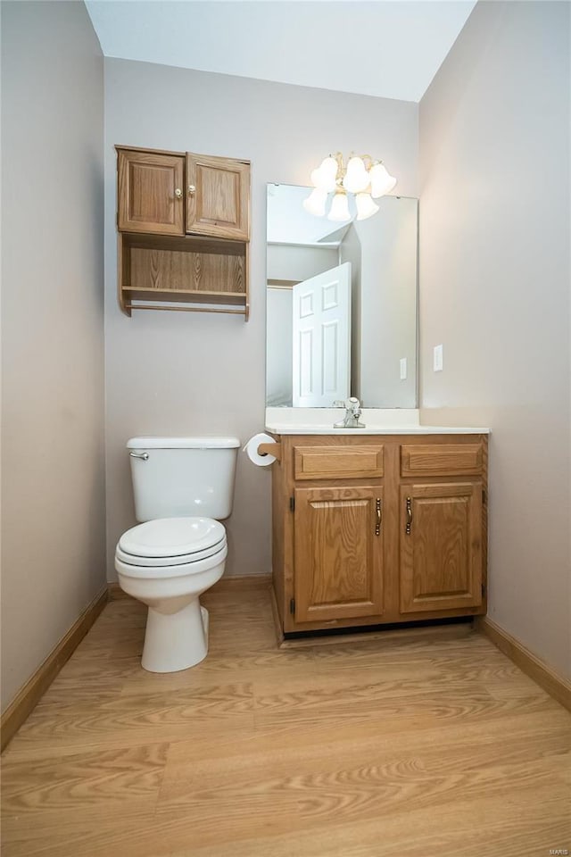 bathroom featuring hardwood / wood-style flooring, vanity, and toilet