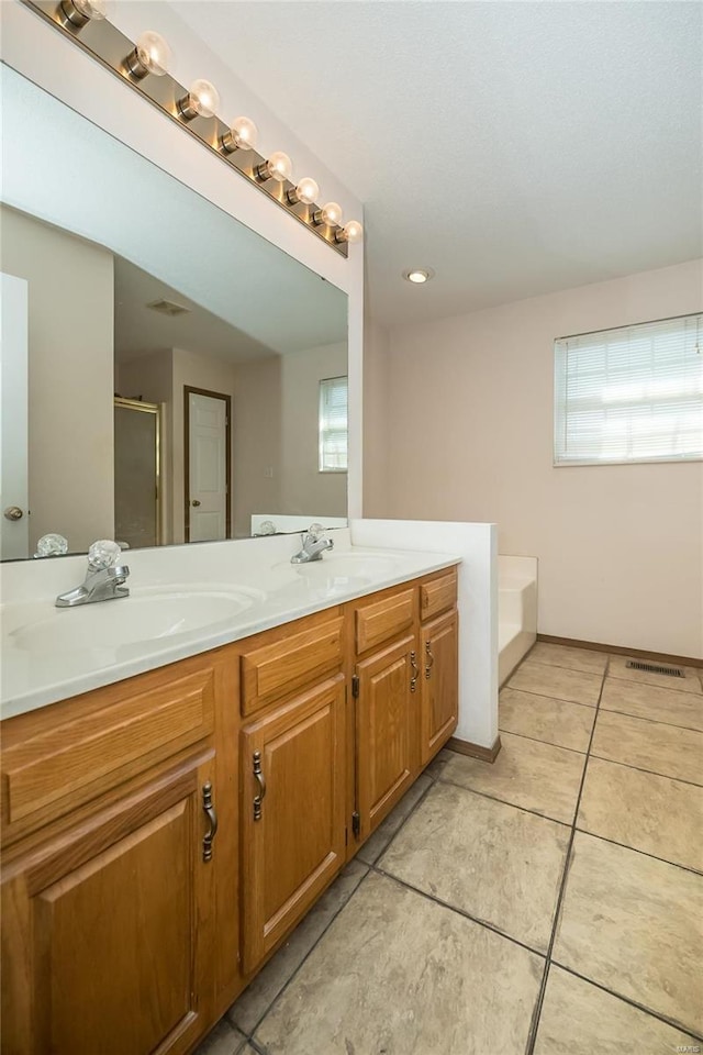 bathroom featuring tile patterned floors, plenty of natural light, vanity, and independent shower and bath